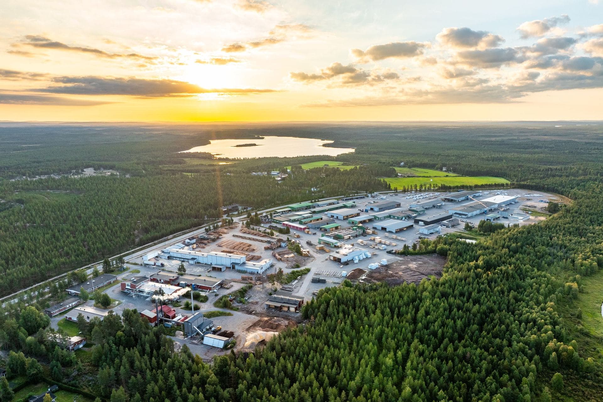 The KONTIO factory in Pudasjärvi at sunset, surrounded by northern forests and lakes