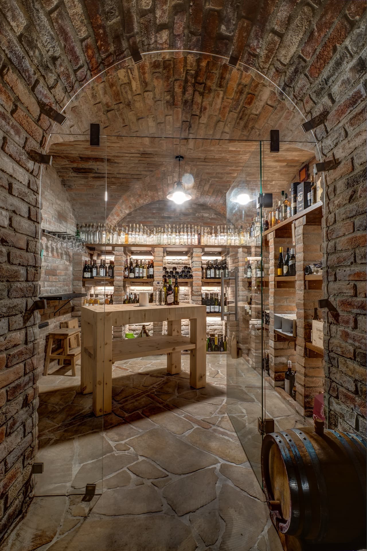 A wine cellar, richly stocked with precious liquids from local sources. Worth noting is the table made from offcuts of glue-laminated Arctic pine beams — a beautiful idea for putting leftover building material to good use