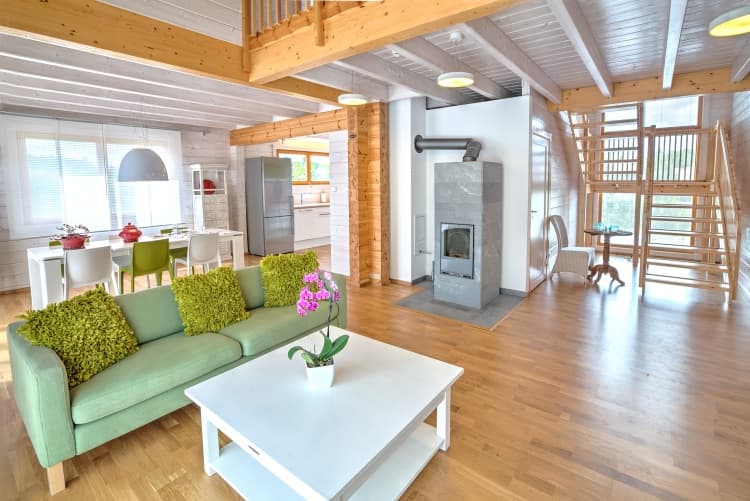 KONTIO log homes — the living room is dominated by a Tulikivi stove