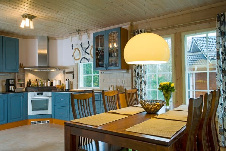 KONTIO Finnish log homes — dining area with kitchen in blue tones