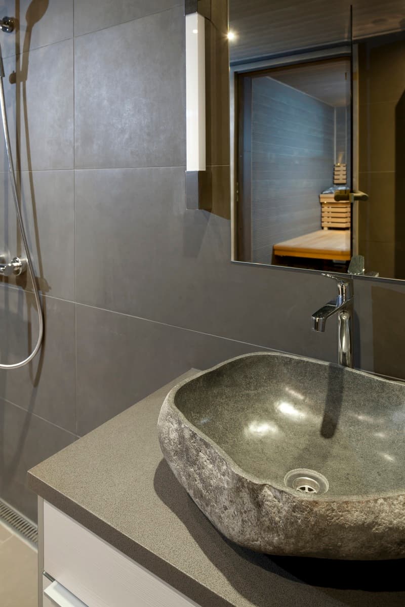 Luxury KONTIO log home, stone washbasin in the bathroom