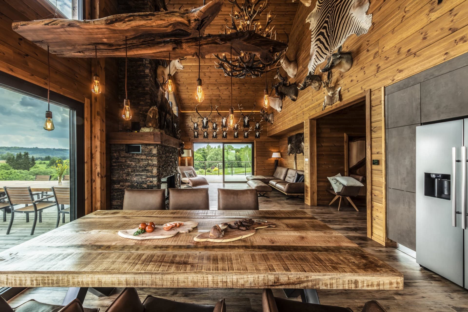 KONTIO timber homes — modern house with basement — interior, table and trophies