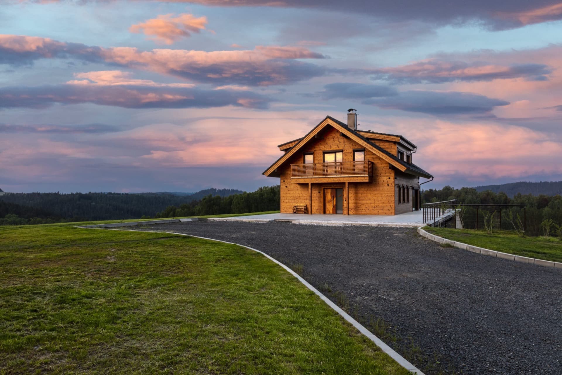 KONTIO timber homes — modern house with basement — exterior, sunset in the distance