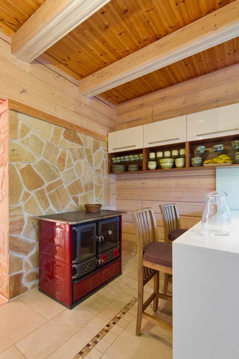KONTIO log home, wood-burning stove in the kitchen
